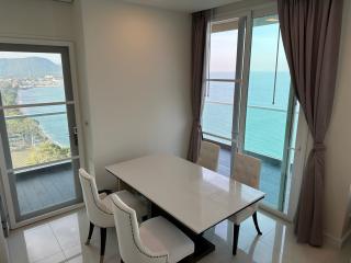 Dining room with ocean view, modern table, and natural light