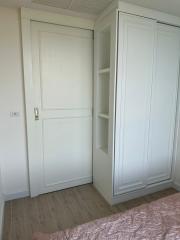 White closet in a bright bedroom interior