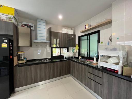 Modern kitchen with dark wooden cabinets and stainless steel appliances