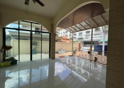 Spacious living room with high ceiling and natural light