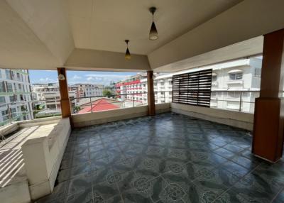 Spacious balcony with tiled floor and urban view