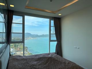 Spacious bedroom with large windows and sea view