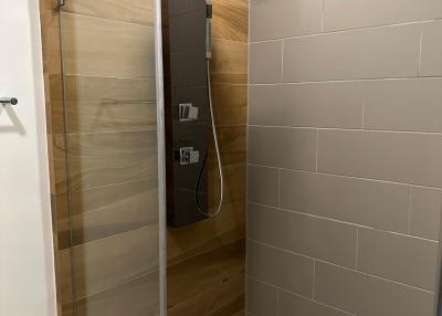 Modern bathroom with glass shower enclosure and wood finishes