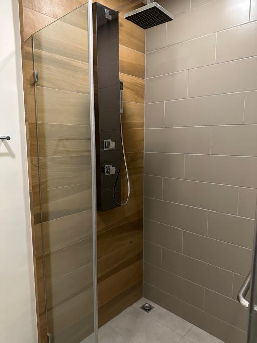 Modern bathroom with glass shower enclosure and wood finishes