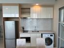 Modern kitchen with stainless steel appliances and white cabinetry