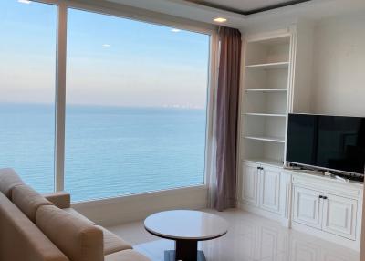 Spacious living room with a large window overlooking the ocean