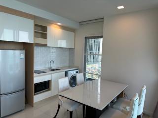 Modern kitchen with integrated appliances and dining area