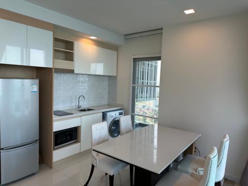 Modern kitchen with integrated appliances and dining area