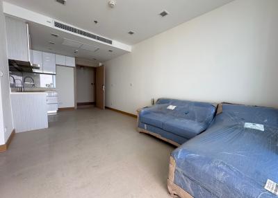 Spacious integrated living room and kitchen space with natural light