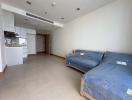 Spacious integrated living room and kitchen space with natural light