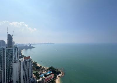 Aerial view of coastal cityscape with high-rise buildings and sea