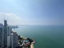 Aerial view of coastal cityscape with high-rise buildings and sea