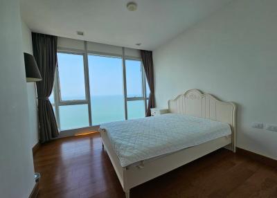 Bright and airy bedroom with large windows and sea view