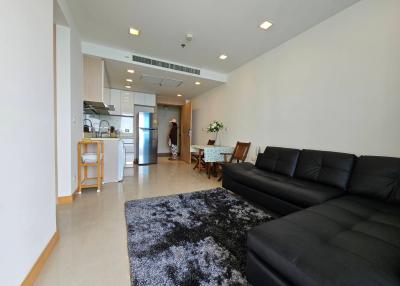 Spacious living room connected to an open kitchen with modern furnishings