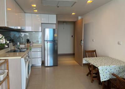Modern kitchen with dining area and stainless steel fridge