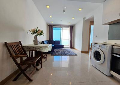 Bright and spacious living room with kitchenette and balcony access