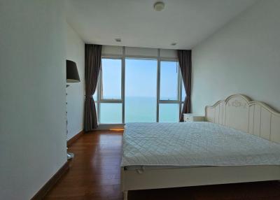 Bright bedroom with ocean view and queen-sized bed