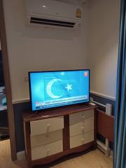 Compact living room with mounted television and air conditioning unit