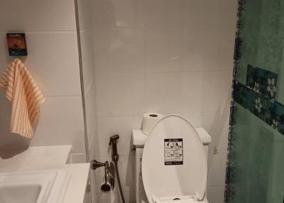 Compact bathroom with white toilet and sink