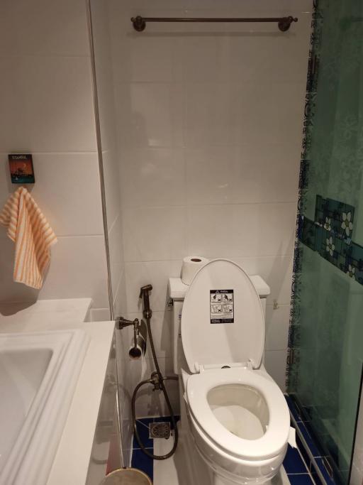 Compact bathroom with white toilet and sink