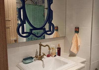 Modern bathroom with stylish mirror and white sink