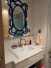 Modern bathroom with stylish mirror and white sink