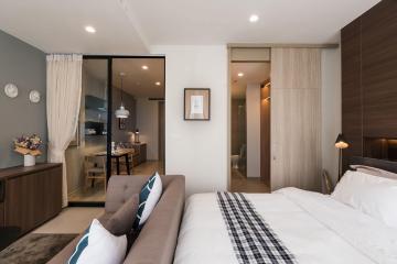 Modern bedroom with attached living space and open concept kitchen