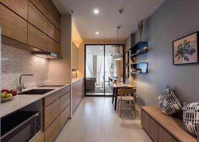 Modern open plan kitchen with adjacent cozy living space and abundant natural light