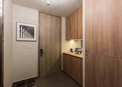 Modern entrance hall with wooden wardrobe and artwork