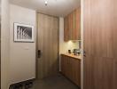 Modern entrance hall with wooden wardrobe and artwork