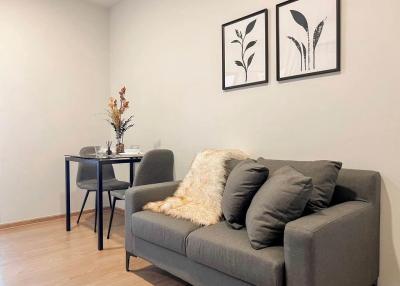 Cozy modern living room with comfortable seating and wall art