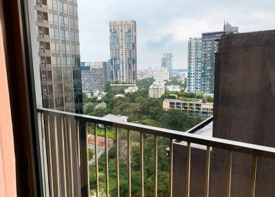 View from the balcony overlooking the cityscape and greenery.