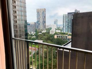 View from the balcony overlooking the cityscape and greenery.