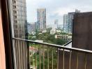 View from the balcony overlooking the cityscape and greenery.