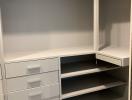 Empty walk-in closet with built-in shelves and drawers