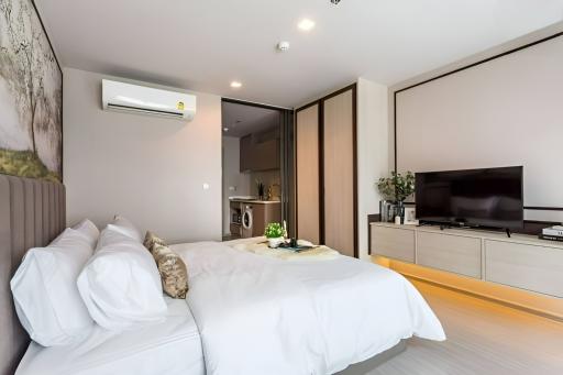 Modern Bedroom with Attached Bathroom and Wall-Mounted Television