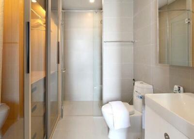 Modern bathroom with glass shower and white fixtures