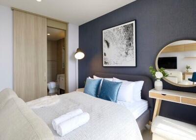 Modern bedroom interior with blue accents and artwork