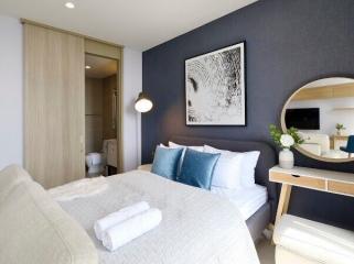 Modern bedroom interior with blue accents and artwork