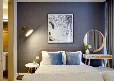 Modern bedroom interior with comfortable bedding, accent pillows, and decorative elements