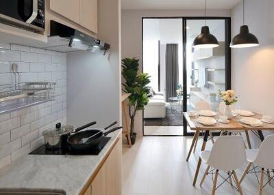 Modern kitchen with open plan leading to a well-lit living room