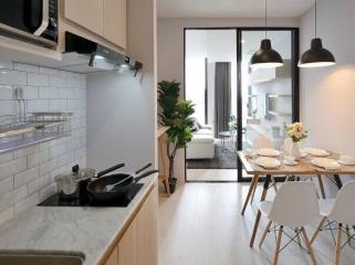 Modern kitchen with open plan leading to a well-lit living room