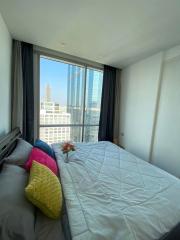 Modern bedroom with a view of the city skyline