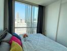 Modern bedroom with a view of the city skyline