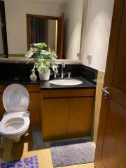 Modern bathroom with wooden cabinets and granite countertop