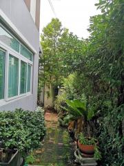 Lush garden pathway beside a residential building