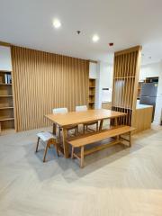 Modern dining area with wood accents and open kitchen layout