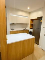 Modern kitchen with wood finishes and integrated appliances