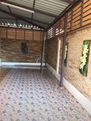 Covered brick patio with decorative tiles and wooden detailing