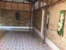 Covered brick patio with decorative tiles and wooden detailing